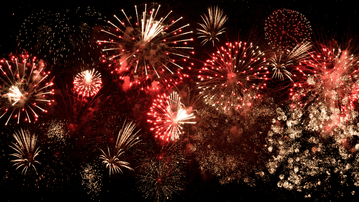 Red and white fireworks on a black background